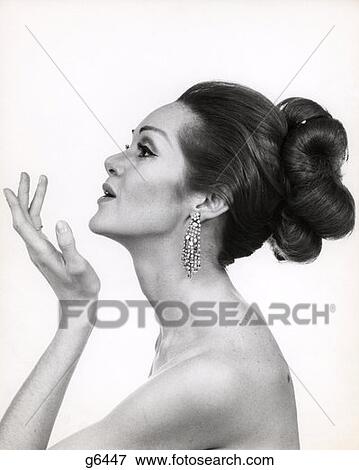 1970S Profile Portrait Of Glamourous Woman With Bare Shoulders & High Fashion Makeup And Hairstyle View Large Photo Image Stock Photo - 1970S Profile Portrait Of Glamourous Woman With Bare Shoulders & High Fashion Makeup And Hairstyle. Fotosearch