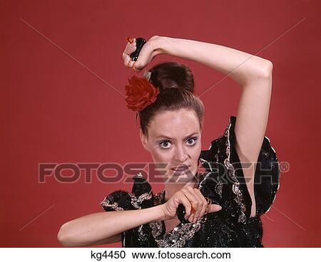 Stock Image - 1970S Retro Woman Flamenco Dancer Playing Castanets. Fotosearch