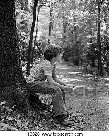 1970S Side View Of Boy Sitting At Foot Of Tree Along Trail In Woods View Large Photo Image Stock Photo - 1970S Side View Of Boy Sitting At Foot Of Tree Along Trail In Woods . Fotosearch