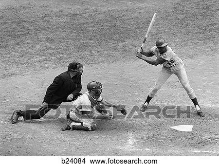 1970S Side View Of Professional Baseball Game With Player At Bat & Catcher & Umpire Behind Him View Large Photo Image Picture - 1970S Side View Of Professional Baseball Game With Player At Bat & Catcher & Umpire Behind Him . Fotosearch