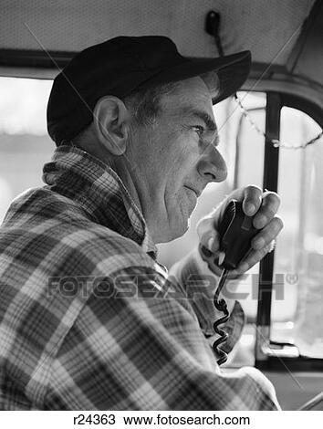 1970S Side View Of Trucker In Plaid Flannel Shirt & Baseball Cap Using Cb Radio View Large Photo Image Stock Image - 1970S Side View Of Trucker In Plaid Flannel Shirt & Baseball Cap Using Cb Radio . Fotosearch