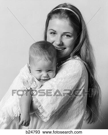 1970S Side View Portrait Of Smiling Mother In Nightgown Holding Baby With Heads Turned To Face Camera View Large Photo Image Stock Image - 1970S Side View Portrait Of Smiling Mother In Nightgown Holding Baby With Heads Turned To Face Camera . Fotosearch