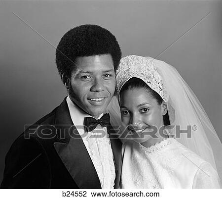 Stock Image - 1970S Smiling Afro-American Portrait Bride & Groom With Arms Around Each Other Looking At Camera . Fotosearch