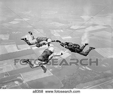 1970S Three Men Holding Hands Sky Diving View Large Photo Image Stock Photo - 1970S Three Men Holding Hands Sky Diving . Fotosearch