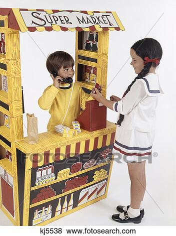1970S Toy Grocery Store Boy As Grocer Cashier Girl As Customer View Large Photo Image Stock Photo - 1970S Toy Grocery Store Boy As Grocer Cashier Girl As Customer . Fotosearch