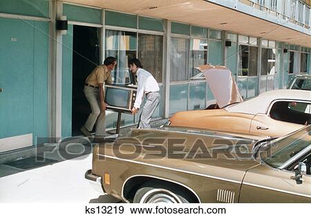 1970S Two Men Stealing Televsion Set From Hotel Room View Large Photo Image Stock Photo - 1970S Two Men Stealing Televsion Set From Hotel Room . Fotosearch