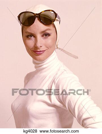 1970S Woman Portrait Wear White Turtle Neck And White Aviator Helmet Hat Strap Sunglasses Up On Forehead Fashion Style View Large Photo Image Stock Photo - 1970S Woman Portrait Wear White Turtle Neck And White Aviator Helmet Hat Strap Sunglasses Up On Forehead Fashion Style . Fotosearch