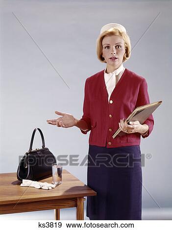 1970S Young Woman By Table Holding Folder With Other Hand Held Out Speaker Teacher Handbag Water Glass View Large Photo Image Stock Photo - 1970S Young Woman By Table Holding Folder With Other Hand Held Out Speaker Teacher Handbag Water Glass. Fotosearch