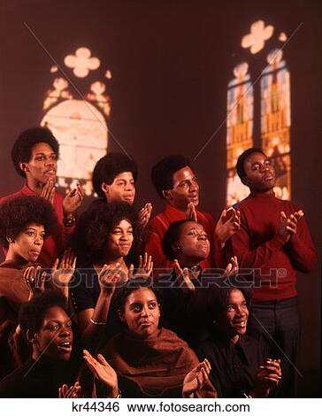 1980 1980S 1970 1970S African-American Gospel Choir Chorus Singers Singing Stained Glass Interior Background View Large Photo Image Stock Photograph - 1980 1980S 1970 1970S African-American Gospel Choir Chorus Singers Singing Stained Glass Interior Background . Fotosearch