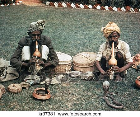 Stock Image - 1980 1980S Snake Charmers India Cobra Basket Flute Snake Turban Music Snakes Hypnotic Hypnotize Charm Charmer. Fotosearch