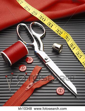Stock Photo - 1980S 1990S Scissors, Pin Cushion, Buttons, Pins Thimble, Thread, Zipper, Fabric And Tape Measure Close-Up Symbolic. Fotosearch