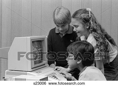 1980S Boy Sitting In Front Of Computer Playing Games Boy & Girl Looking On Over His Shoulder View Large Photo Image Stock Photograph - 1980S Boy Sitting In Front Of Computer Playing Games Boy & Girl Looking On Over His Shoulder . Fotosearch
