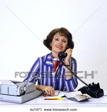 1980S Brunette Woman On Black Telephone Blue White Stripe Blouse Smiling At Desk Manual Typewriter Rolodex Secretary View Large Photo Image Stock Image - 1980S Brunette Woman On Black Telephone Blue White Stripe Blouse Smiling At Desk Manual Typewriter Rolodex Secretary. Fotosearch