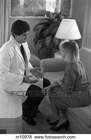 1980S Doctor Sitting Coffee Table Waiting Room Talking To Woman Patient Family Member On Couch Compassion View Large Photo Image Stock Photo - 1980S Doctor Sitting Coffee Table Waiting Room Talking To Woman Patient Family Member On Couch Compassion. Fotosearch