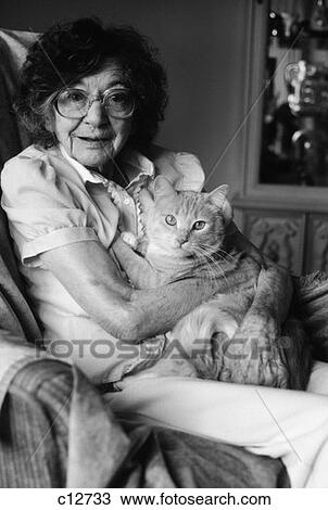 1980S Elderly Senior Woman Wear Glasses Holding Tabby Cat In Her Arms Lap Pet Geriatric Companion Old Age Therapy Animal View Large Photo Image Stock Image - 1980S Elderly Senior Woman Wear Glasses Holding Tabby Cat In Her Arms Lap Pet Geriatric Companion Old Age Therapy Animal. Fotosearch