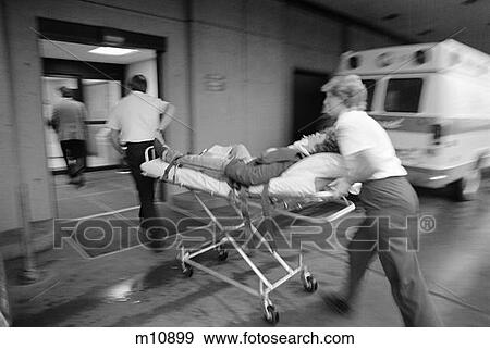 Stock Photo - 1980S Emt Team Rushing Patient Into Hospital On Stretcher . Fotosearch