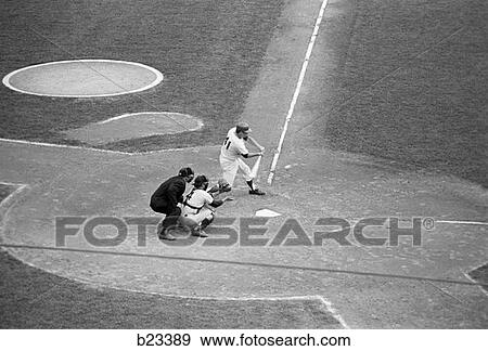 1980S Professional Baseball Game With Batter About To Hit Ball As Catcher And Umpire Look On View Large Photo Image Stock Photo - 1980S Professional Baseball Game With Batter About To Hit Ball As Catcher And Umpire Look On . Fotosearch