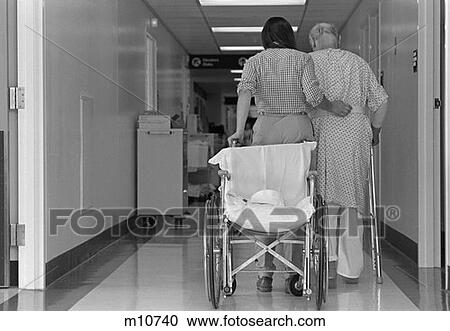 1980S Rear View Of Woman With Arm Around Elderly Man Using Walker Wheelchair Behind Them View Large Photo Image Stock Image - 1980S Rear View Of Woman With Arm Around Elderly Man Using Walker Wheelchair Behind Them . Fotosearch