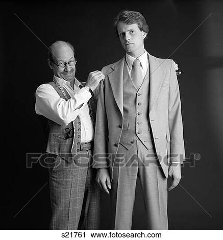 1980S Smiling Tailor Fitting Three Piece Suit On Business Man Adusting Shoulders Custom Made Alteration View Large Photo Image Stock Image - 1980S Smiling Tailor Fitting Three Piece Suit On Business Man Adusting Shoulders Custom Made Alteration . Fotosearch