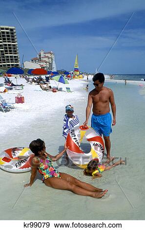 1990 1990S Family On Beach Sandestin Resort Hotel In Background Destin Florida View Large Photo Image Stock Photo - 1990 1990S Family On Beach Sandestin Resort Hotel In Background Destin Florida . Fotosearch