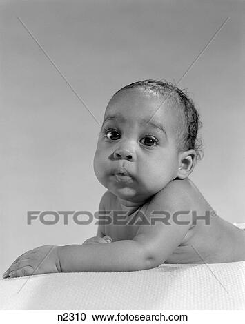 African American Baby Portrait Lying On Stomach Arms Out Infront Looking At Camera Chubby Cute View Large Photo Image Stock Image - African American Baby Portrait Lying On Stomach Arms Out Infront Looking At Camera Chubby Cute . Fotosearch