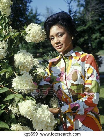 African American Woman Flowers Garden Portrait Gardening 1970 1970S Retro View Large Photo Image Stock Photo - African American Woman Flowers Garden Portrait Gardening 1970 1970S Retro . Fotosearch