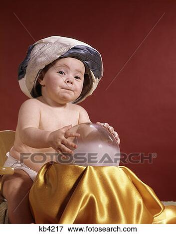 Baby With Fortune Teller Turban Headdress Holding Hands On Crystal Ball Studio View Large Photo Image Stock Photo - Baby With Fortune Teller Turban Headdress Holding Hands On Crystal Ball Studio. Fotosearch