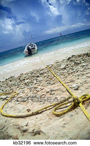 Stock Photograph - Boat Anchored To Beach Caribbean Ocean Riviera Maya, Mexico. Fotosearch