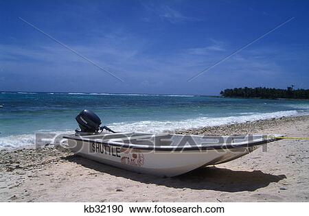 Stock Image - Boat On Caribbean Beach Riviera Maya, Mexico. Fotosearch