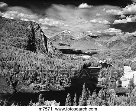 Bow River Valley Banff National Park Alberta Canada - River Buried Between Mountains With Evergreen Trees View Large Photo Image Stock Image - Bow River Valley Banff National Park Alberta Canada - River Buried Between Mountains With Evergreen Trees . Fotosearch