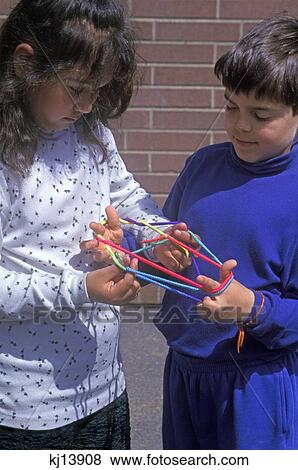 Boy And Girl Playing Yarn Hand Game Cats In The Cradle View Large Photo Image Stock Photo - Boy And Girl Playing Yarn Hand Game Cats In The Cradle. Fotosearch