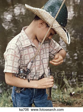 Boy Wearing Straw Hat Removing Hook From Mouth Of Fish Outdoor View Large Photo Image Stock Photograph - Boy Wearing Straw Hat Removing Hook From Mouth Of Fish Outdoor . Fotosearch