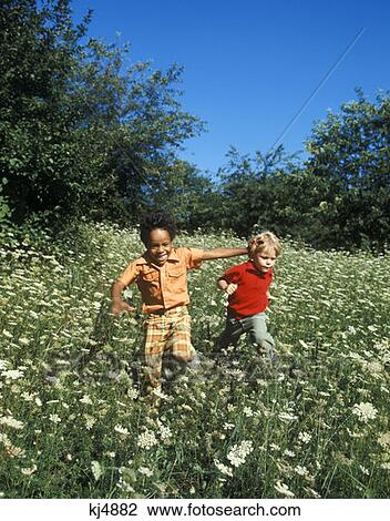 Boys Running Playing Field Laughing 1970 1970S Retro View Large Photo Image Stock Image - Boys Running Playing Field Laughing 1970 1970S Retro . Fotosearch