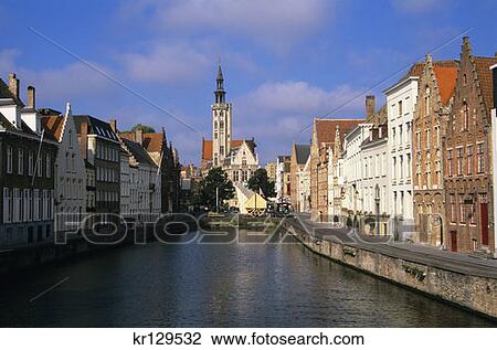Stock Image - Bruges Belgium View Down Canal To Poortersloge And Jan Van Eyckplein . Fotosearch