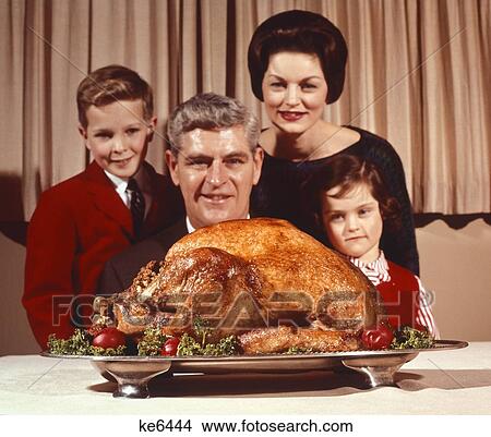 C143-0843 Color Family Looking At Holiday Turkey Man Woman Boy Girl Indoor View Large Photo Image Picture - C143-0843 Color Family Looking At Holiday Turkey Man Woman Boy Girl Indoor. Fotosearch