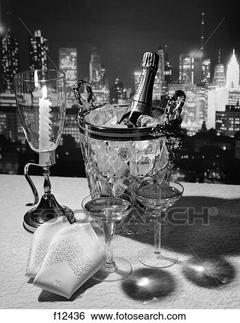 Champagne Bottle In Ice Bucket With Glasses Candle & Napkins On Table & New York City Night Skyline In Background View Large Photo Image Stock Photograph - Champagne Bottle In Ice Bucket With Glasses Candle & Napkins On Table & New York City Night Skyline In Background. Fotosearch