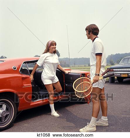 Couple Getting Out Of Car Man Holding Tennis Rackets Red White 1970 1970S Retro View Large Photo Image Stock Photo - Couple Getting Out Of Car Man Holding Tennis Rackets Red White 1970 1970S Retro . Fotosearch