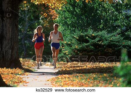 Couple Jogging In Autumn View Large Photo Image Stock Photo - Couple Jogging In Autumn . Fotosearch