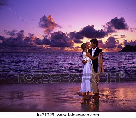 Couple On The Beach At Sunrise, Dressed Up View Large Photo Image Stock Photo - Couple On The Beach At Sunrise, Dressed Up. Fotosearch
