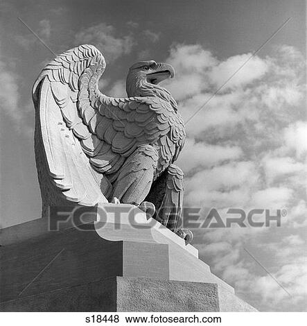 Stock Photo - Eagle Statue Against Sky Clouds Eagle Government Wings Spread Feathers Talons Curled Over Edge Of Base Philadelphia 30Th Street. Fotosearch