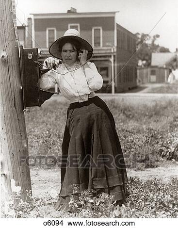 Early 1900S Woman Talking On Telephone Leaning Against Pole Outdoor View Large Photo Image Picture - Early 1900S Woman Talking On Telephone Leaning Against Pole Outdoor . Fotosearch