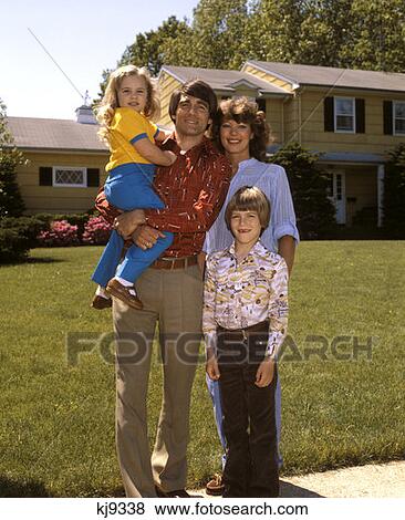 Family 1 Son 1 Daughter Standing Outside House Home Portrait Smiling 1980 1980S Retro View Large Photo Image Stock Photo - Family 1 Son 1 Daughter Standing Outside House Home Portrait Smiling 1980 1980S Retro . Fotosearch