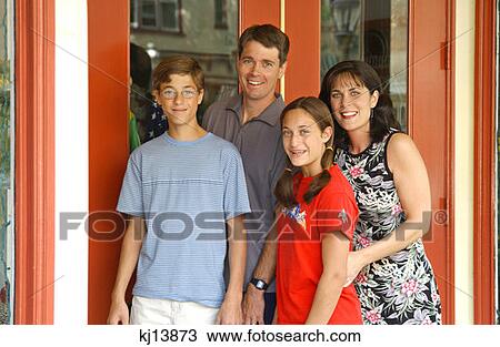 Stock Image - Family Of Four Posed Outside Of Shop. Fotosearch