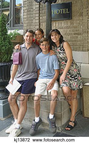 Family Of Four Posing Outside Hotel, Tourists View Large Photo Image Stock Image - Family Of Four Posing Outside Hotel, Tourists. Fotosearch