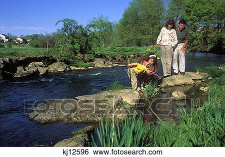 Family Of Four Standing On Rocks In Stream View Large Photo Image Stock Photograph - Family Of Four Standing On Rocks In Stream . Fotosearch
