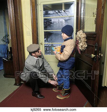 Father And Son Getting Ready To Leave House On A Cold Winter Day Father Tying Laces On Son'S Boots Retro 1970 1970S View Large Photo Image Stock Photography - Father And Son Getting Ready To Leave House On A Cold Winter Day Father Tying Laces On Son'S Boots Retro 1970 1970S. Fotosearch