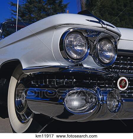 Stock Photo - Front Headlight Grill And Wheel Of A Cadillac. Fotosearch