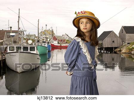 Girl Wearing Old Fashioned Blue Dress Straw Hat With Flowers At Fishing Port Peggys Cove Nova Scotia Canada View Large Photo Image Stock Image - Girl Wearing Old Fashioned Blue Dress Straw Hat With Flowers At Fishing Port Peggys Cove Nova Scotia Canada . Fotosearch