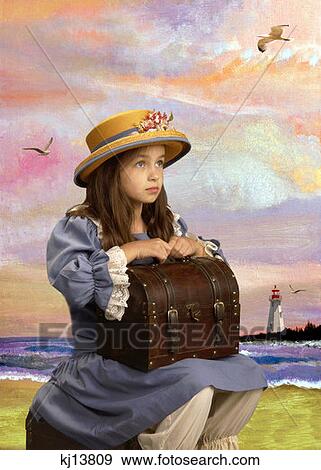 Girl Wearing Old Fashioned Blue Dress Bloomers And Straw Hat With Flowers Holding Trunk Suitcase Sitting On Beach View Large Photo Image Stock Photo - Girl Wearing Old Fashioned Blue Dress Bloomers And Straw Hat With Flowers Holding Trunk Suitcase Sitting On Beach . Fotosearch