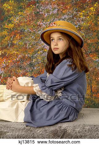 Girl Wearing Old Fashioned Blue Dress Bloomers And Straw Hat With Flowers Sitting On Ledge By Autumn Trees View Large Photo Image Stock Photography - Girl Wearing Old Fashioned Blue Dress Bloomers And Straw Hat With Flowers Sitting On Ledge By Autumn Trees . Fotosearch